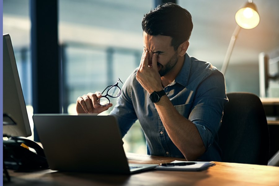 Man exhausted at his desk